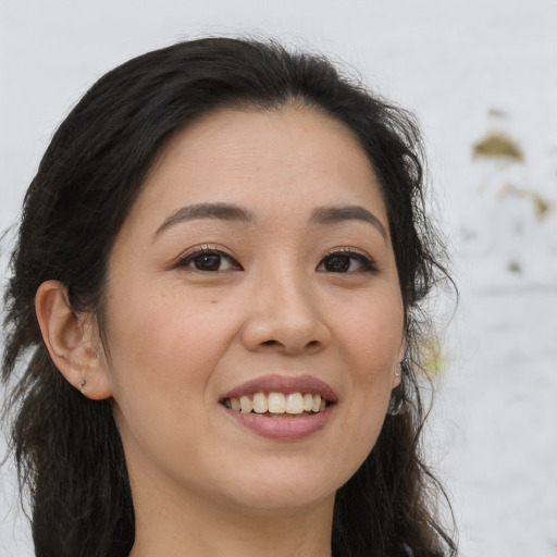 Joyful asian young-adult female with long  brown hair and brown eyes