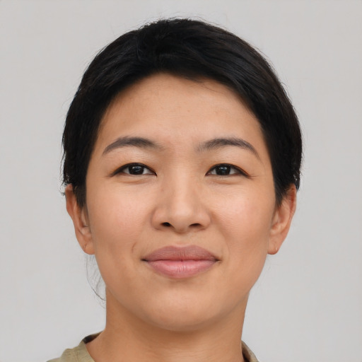 Joyful asian young-adult female with short  black hair and brown eyes