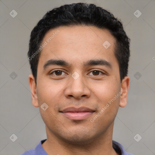 Joyful latino young-adult male with short  black hair and brown eyes