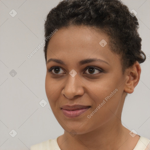 Joyful black young-adult female with short  brown hair and brown eyes