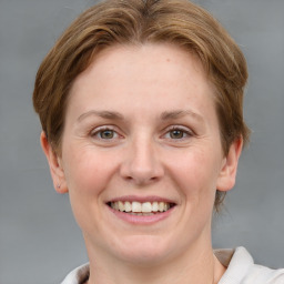 Joyful white adult female with medium  brown hair and grey eyes