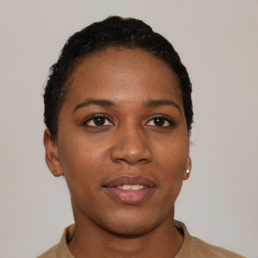 Joyful black young-adult female with short  black hair and brown eyes
