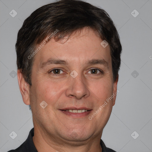 Joyful white adult male with short  brown hair and brown eyes