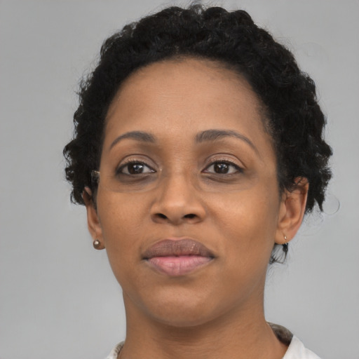 Joyful black adult female with short  black hair and brown eyes