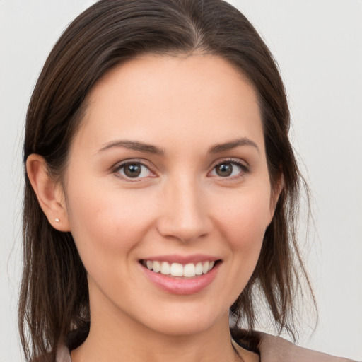 Joyful white young-adult female with medium  brown hair and brown eyes