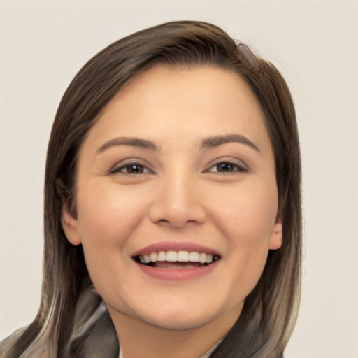 Joyful white young-adult female with long  brown hair and brown eyes