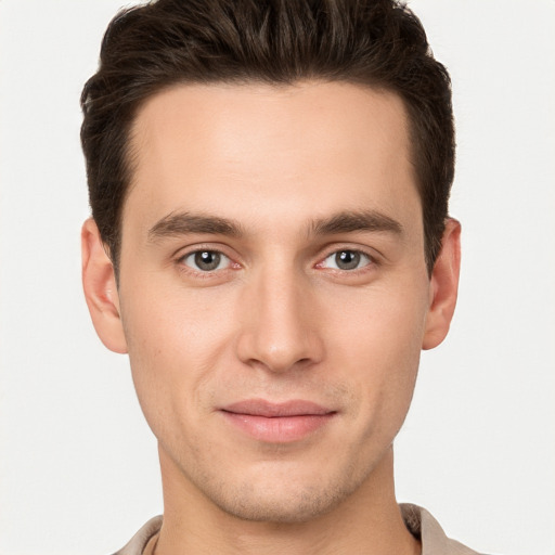 Joyful white young-adult male with short  brown hair and brown eyes