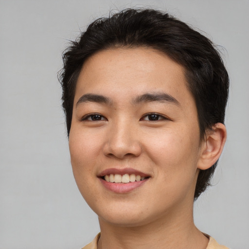 Joyful asian young-adult female with short  brown hair and brown eyes