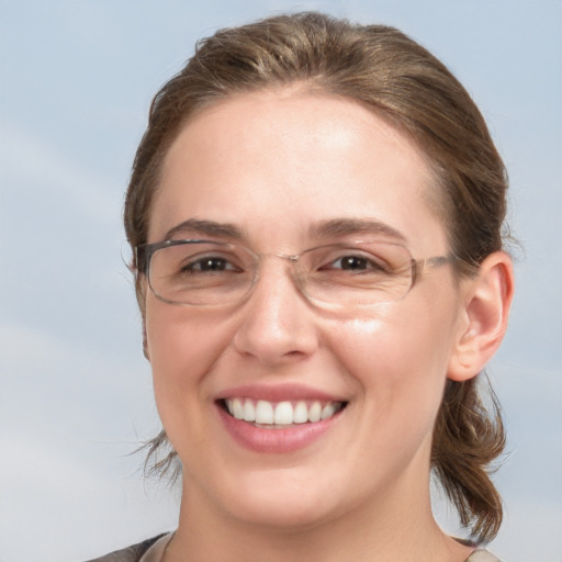 Joyful white young-adult female with medium  brown hair and grey eyes