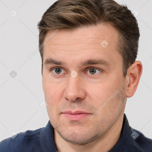 Joyful white adult male with short  brown hair and brown eyes