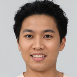 Joyful asian young-adult male with short  black hair and brown eyes