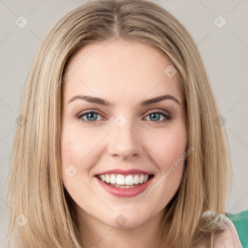 Joyful white young-adult female with long  brown hair and green eyes