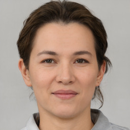 Joyful white adult female with medium  brown hair and brown eyes