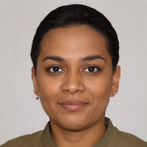 Joyful black young-adult female with short  black hair and brown eyes