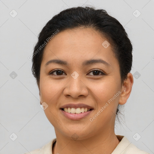 Joyful latino young-adult female with short  brown hair and brown eyes