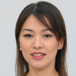 Joyful asian young-adult female with long  brown hair and brown eyes