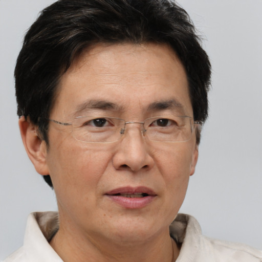 Joyful asian adult male with short  brown hair and brown eyes