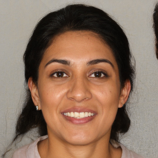 Joyful white adult female with medium  brown hair and brown eyes
