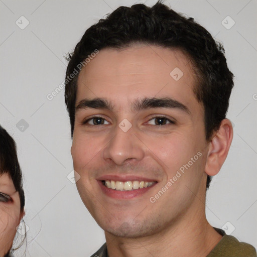 Joyful white young-adult male with short  black hair and brown eyes