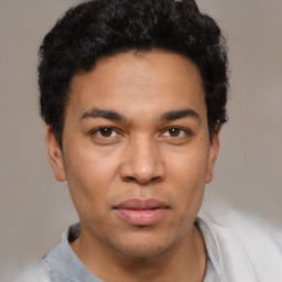 Joyful latino young-adult male with short  brown hair and brown eyes