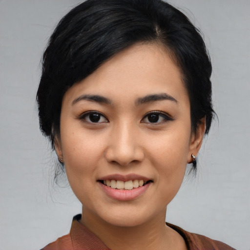 Joyful asian young-adult female with medium  black hair and brown eyes