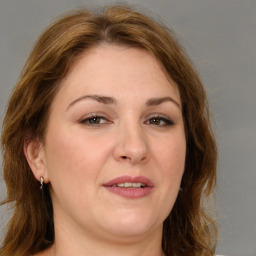 Joyful white adult female with medium  brown hair and brown eyes