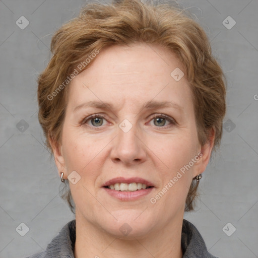 Joyful white adult female with medium  brown hair and blue eyes