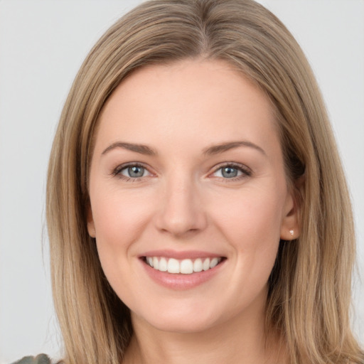 Joyful white young-adult female with long  brown hair and green eyes