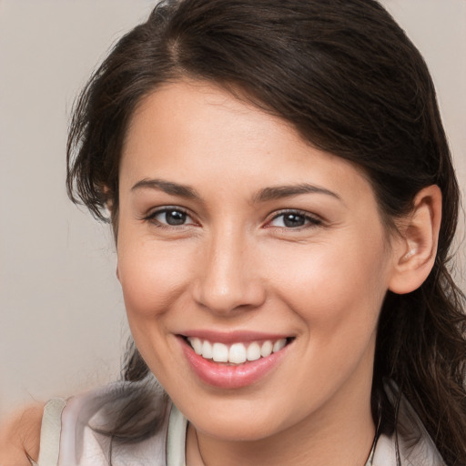 Joyful white young-adult female with medium  brown hair and brown eyes