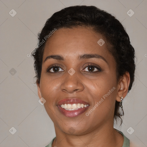 Joyful black young-adult female with medium  brown hair and brown eyes