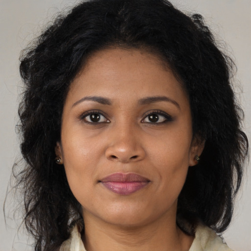 Joyful black young-adult female with medium  brown hair and brown eyes