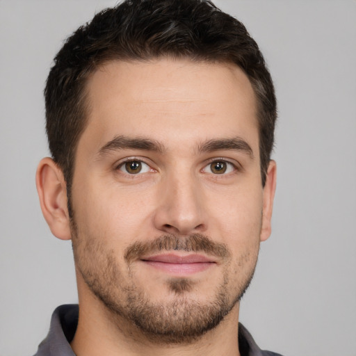 Joyful white young-adult male with short  brown hair and brown eyes