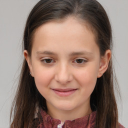 Joyful white child female with long  brown hair and brown eyes