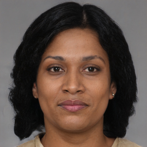 Joyful black adult female with medium  brown hair and brown eyes
