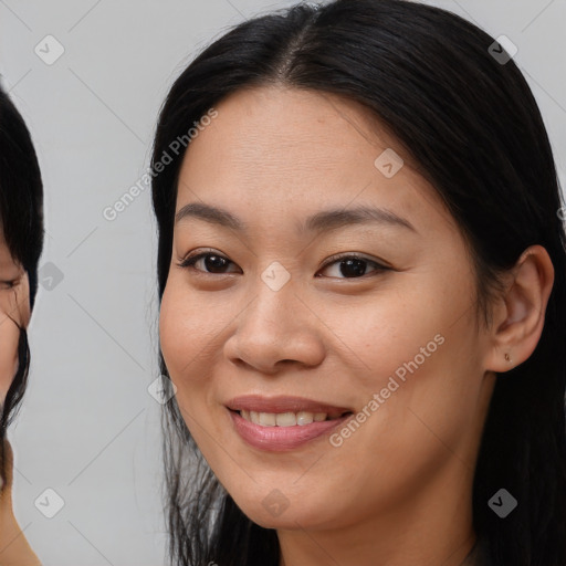 Joyful asian young-adult female with long  brown hair and brown eyes