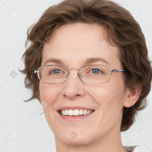 Joyful white adult female with medium  brown hair and green eyes