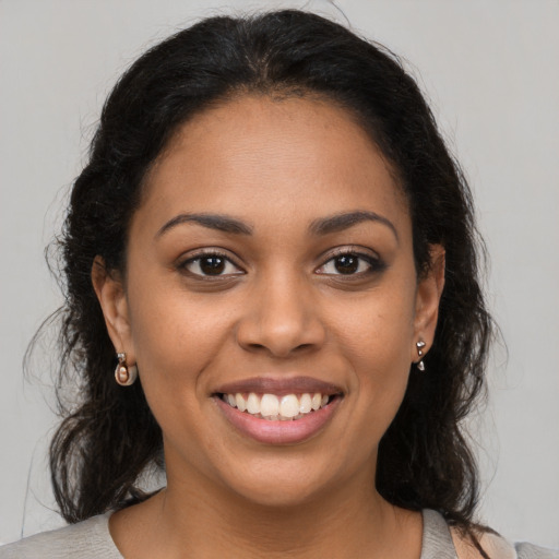 Joyful latino young-adult female with medium  brown hair and brown eyes