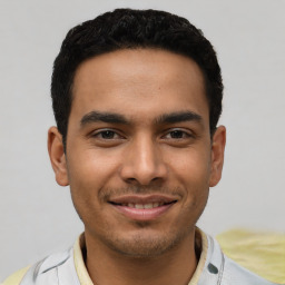 Joyful latino young-adult male with short  black hair and brown eyes