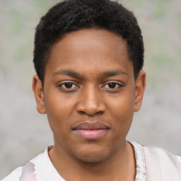 Joyful black young-adult male with short  brown hair and brown eyes