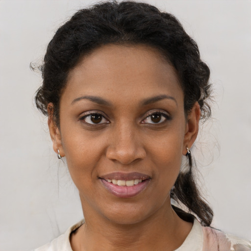 Joyful black young-adult female with short  brown hair and brown eyes