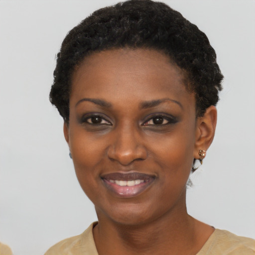 Joyful black young-adult female with short  black hair and brown eyes