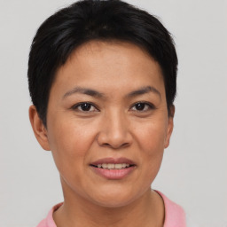 Joyful asian adult female with short  brown hair and brown eyes