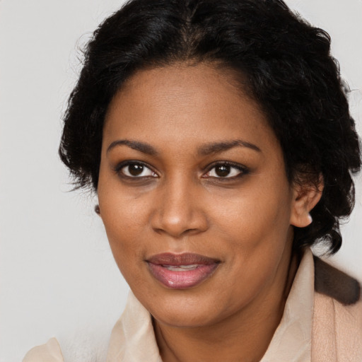Joyful black adult female with short  brown hair and brown eyes