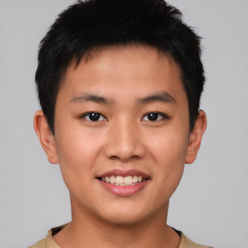Joyful asian young-adult male with short  brown hair and brown eyes