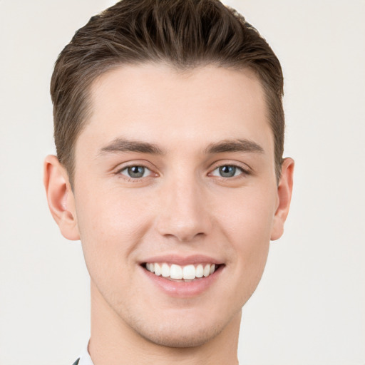 Joyful white young-adult male with short  brown hair and brown eyes