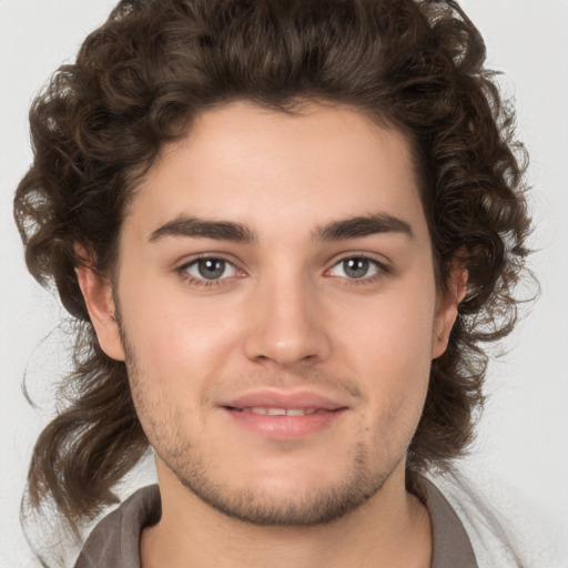 Joyful white young-adult male with medium  brown hair and brown eyes