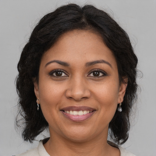Joyful black young-adult female with medium  brown hair and brown eyes
