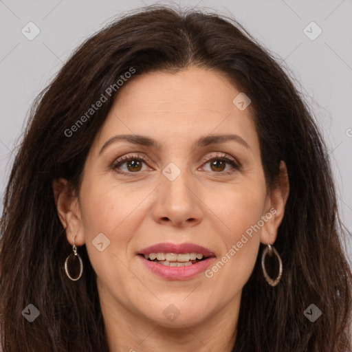 Joyful white adult female with long  brown hair and brown eyes