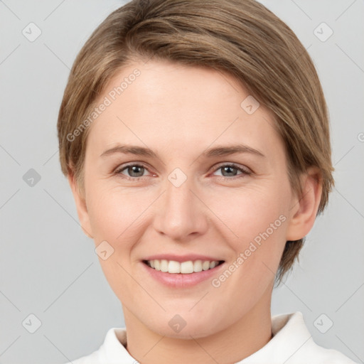 Joyful white young-adult female with short  brown hair and grey eyes