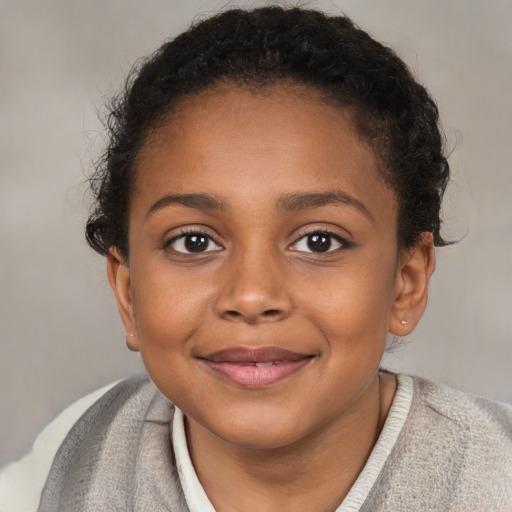 Joyful black child female with short  brown hair and brown eyes